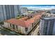 Aerial view showing condos with red tile roofs, the Hilton Hotel, and the ocean in the background at 200 4Th S Ave # 229, St Petersburg, FL 33701