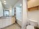 Bright bathroom boasts a large mirror, vanity with storage, and a shower-tub combination at 200 4Th S Ave # 229, St Petersburg, FL 33701