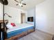 Bedroom features a ceiling fan, wood-look flooring, and a white dresser with a television at 200 4Th S Ave # 229, St Petersburg, FL 33701