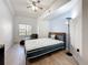Bright bedroom with hardwood floors, modern ceiling fan, and comfortable leather chaise lounge near the window at 200 4Th S Ave # 229, St Petersburg, FL 33701