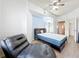 Well-lit bedroom with a modern ceiling fan, chaise lounge, view into the en-suite bath and walk-in closet at 200 4Th S Ave # 229, St Petersburg, FL 33701