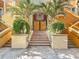 Stairs with decorative tiles leading to a secured condo entrance, flanked by planters and palm trees at 200 4Th S Ave # 229, St Petersburg, FL 33701