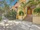 Tropical plants surround stairs with decorative tiles leading to a secure condo entrance at 200 4Th S Ave # 229, St Petersburg, FL 33701