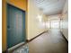 Well-lit hallway with multiple doors and a unique peacock feather doormat in front of unit 229 at 200 4Th S Ave # 229, St Petersburg, FL 33701