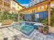 Community hot tub with beautiful blue tiling, adjacent bench seating, and lush landscaping at 200 4Th S Ave # 229, St Petersburg, FL 33701