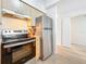 Bright kitchen features stainless steel appliances and light wood cabinets with a view to the hallway at 200 4Th S Ave # 229, St Petersburg, FL 33701