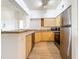 Open kitchen with modern stainless steel appliances and maple cabinets at 200 4Th S Ave # 229, St Petersburg, FL 33701