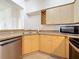 Kitchen featuring stainless steel dishwasher, microwave, maple cabinets and laminate flooring at 200 4Th S Ave # 229, St Petersburg, FL 33701