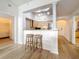 Open concept living room and dining area with wood floors, kitchen access, and bright natural lighting at 200 4Th S Ave # 229, St Petersburg, FL 33701