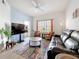 Living room features bright natural lighting, a ceiling fan, an access door, and modern decor at 200 4Th S Ave # 229, St Petersburg, FL 33701