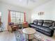 Bright living room with ceiling fan, area rug, leather seating, and natural light through a large window at 200 4Th S Ave # 229, St Petersburg, FL 33701