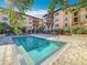Relaxing community pool area with lounge chairs surrounded by lush landscaping and building views at 200 4Th S Ave # 229, St Petersburg, FL 33701