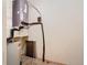Utility room featuring a water heater, and some exposed pipes and wiring at 200 4Th S Ave # 229, St Petersburg, FL 33701