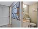 Community bathroom with decorated walls, sink, and a toilet at 224 Aspen Cir # 224, Seminole, FL 33777