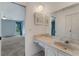 Vanity area featuring marble countertops, a decorative mirror, and tile flooring at 224 Aspen Cir # 224, Seminole, FL 33777