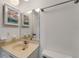 Vanity with sink, framed mirror, and wall with outlets and a nautical themed picture at 224 Aspen Cir # 224, Seminole, FL 33777