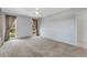 Neutral bedroom with a ceiling fan, large windows, light gray walls, and plush carpeting at 224 Aspen Cir # 224, Seminole, FL 33777