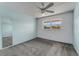 Bedroom with a gray carpet, light blue walls, a ceiling fan, and a window bringing in natural light at 224 Aspen Cir # 224, Seminole, FL 33777
