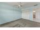 Well-lit bedroom features gray carpeting, light blue walls, closet, and doorway leading to the bathroom at 224 Aspen Cir # 224, Seminole, FL 33777