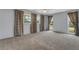 Spacious bedroom with large windows, decorative curtains, and neutral-toned carpeting at 224 Aspen Cir # 224, Seminole, FL 33777