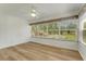 Bright and open bedroom with ceiling fan, and community view through the window at 224 Aspen Cir # 224, Seminole, FL 33777