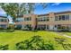 Exterior view of a multi-story condo building with lush green lawn at 224 Aspen Cir # 224, Seminole, FL 33777