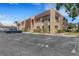 Exterior of a charming two-story condo building showing parking, landscaping and stone details at 224 Aspen Cir # 224, Seminole, FL 33777