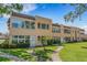 Charming condo building with well-maintained landscaping and a curved walkway at 224 Aspen Cir # 224, Seminole, FL 33777