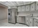 Corner of kitchen with stainless steel refrigerator and dishwasher, corner sink with granite countertops at 224 Aspen Cir # 224, Seminole, FL 33777