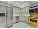 Corner of kitchen with stainless steel refrigerator, dishwasher, corner sink and original oven and microwave at 224 Aspen Cir # 224, Seminole, FL 33777