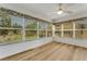 Relaxing enclosed lanai with view of community landscaping, blinds, and ceiling fan at 224 Aspen Cir # 224, Seminole, FL 33777