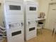 Community laundry with stacked washers and dryers with folding counter at 224 Aspen Cir # 224, Seminole, FL 33777