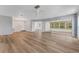 Bright living room featuring modern flooring, updated lighting, and screened lanai access at 224 Aspen Cir # 224, Seminole, FL 33777