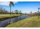 Scenic view of a pond surrounded by lush greenery and palm trees at 224 Aspen Cir # 224, Seminole, FL 33777