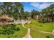 Aerial view of sparkling community pool, patio, lawn, and surrounding buildings at 224 Aspen Cir # 224, Seminole, FL 33777