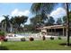 Beautiful community pool surrounded by lush greenery and a tennis court providing recreational activities at 224 Aspen Cir # 224, Seminole, FL 33777