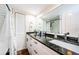 Bathroom featuring a granite countertop, white cabinets, and a shower with white subway tile at 2706 11Th Ct, Palm Harbor, FL 34684