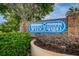 Wedgewood community sign surrounded by lush landscaping and mature trees under a partly cloudy sky at 2706 11Th Ct, Palm Harbor, FL 34684