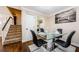 Dining room featuring a glass-top table, leather chairs, staircase access, and adjacent utility room at 2706 11Th Ct, Palm Harbor, FL 34684
