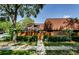 Charming townhome exterior with a wooden fence, tile roof, and lush landscaping at 2706 11Th Ct, Palm Harbor, FL 34684