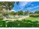 Manicured walkway surrounded by lush gardens lead to community pool and recreation area at 2706 11Th Ct, Palm Harbor, FL 34684