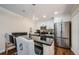 Modern kitchen with stainless steel appliances, granite counters, and breakfast bar seating at 2706 11Th Ct, Palm Harbor, FL 34684