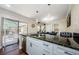 Kitchen island with granite countertop, stainless steel appliances, and sliding doors to the patio at 2706 11Th Ct, Palm Harbor, FL 34684