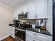 Bright kitchen with white cabinets, stainless steel appliances, and granite countertops at 2706 11Th Ct, Palm Harbor, FL 34684