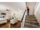 Bright living room with hardwood floors, white furniture, and staircase to the upper level at 2706 11Th Ct, Palm Harbor, FL 34684