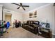Cozy living room with a plush leather sofa and bright decor, featuring a ceiling fan and ample natural light at 2706 11Th Ct, Palm Harbor, FL 34684