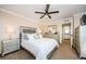 Spacious main bedroom with a ceiling fan, plush carpet, and access to an ensuite bathroom at 2706 11Th Ct, Palm Harbor, FL 34684