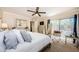Bright main bedroom featuring sliding glass doors, a ceiling fan, and neutral decor at 2706 11Th Ct, Palm Harbor, FL 34684