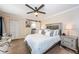 Cozy main bedroom featuring a ceiling fan, sliding barn door, and ample closet space at 2706 11Th Ct, Palm Harbor, FL 34684