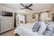 Comfortable main bedroom with a ceiling fan, a large window, and stylish furniture at 2706 11Th Ct, Palm Harbor, FL 34684